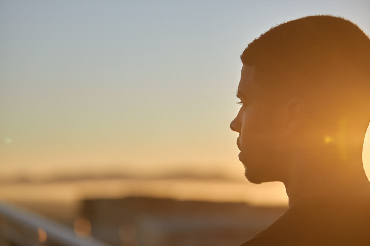Content male outside thinking about his emotional well being.