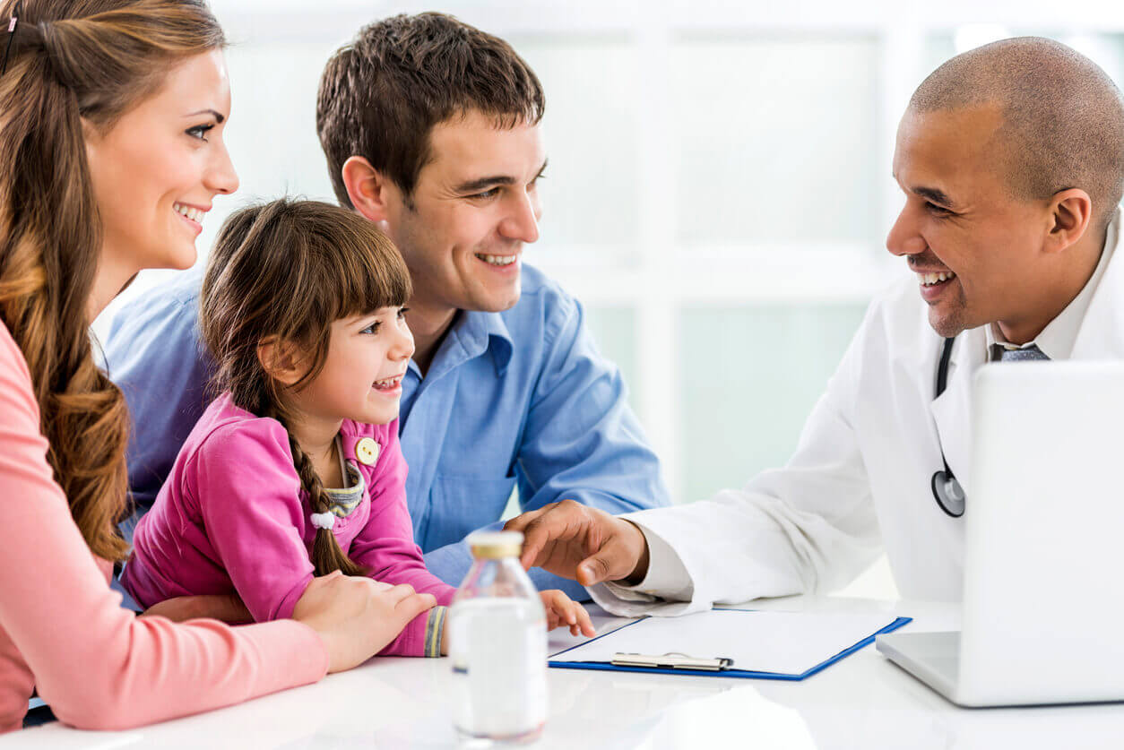 A family of three is receiving medical counseling from holistic family medicine providers.