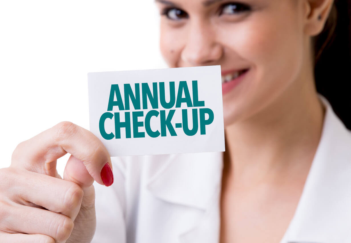 Annual Check-up written on the card a primary care provider is holding.