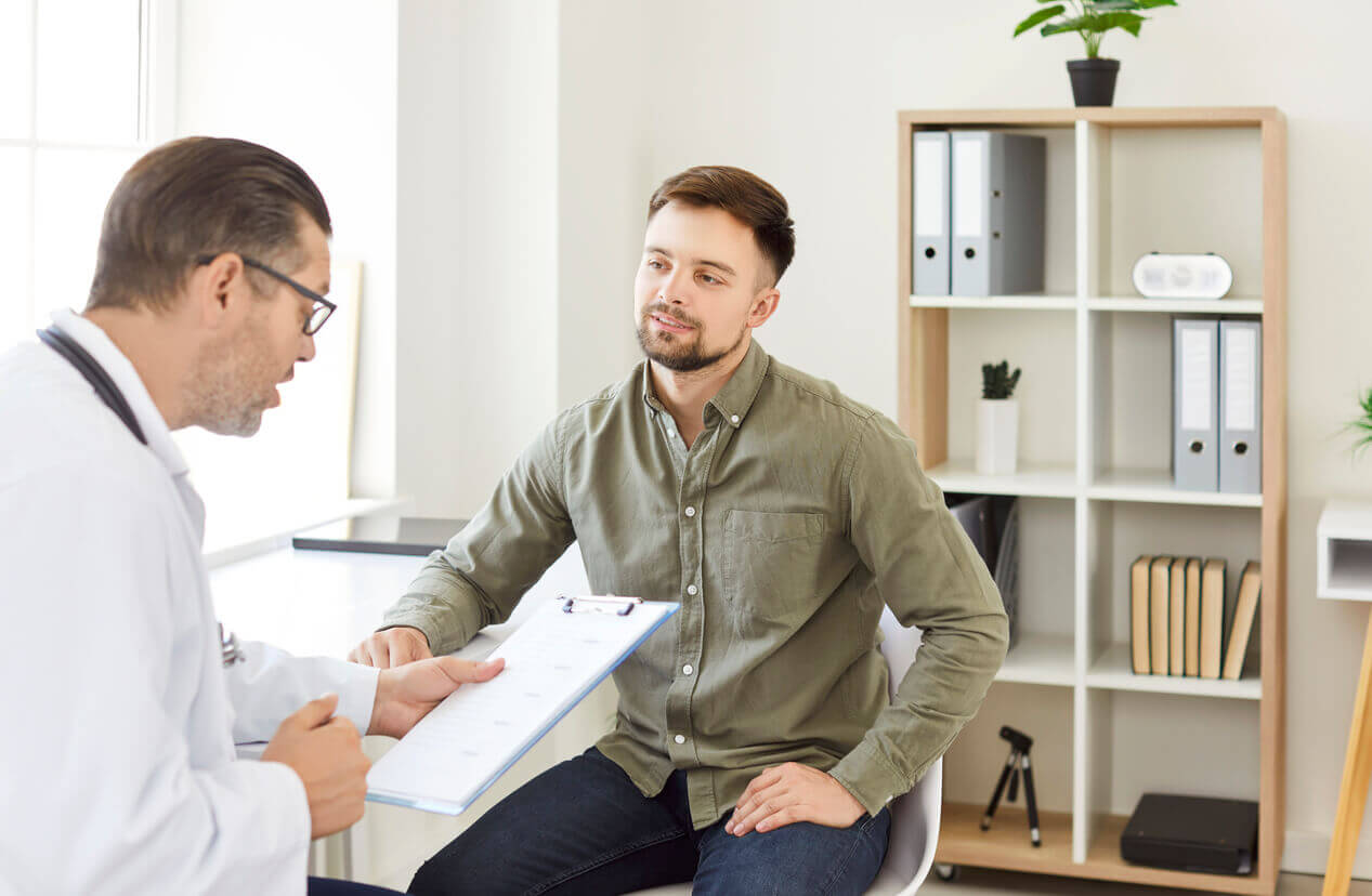 Man patient visiting a doctor in medical clinic during checkup.